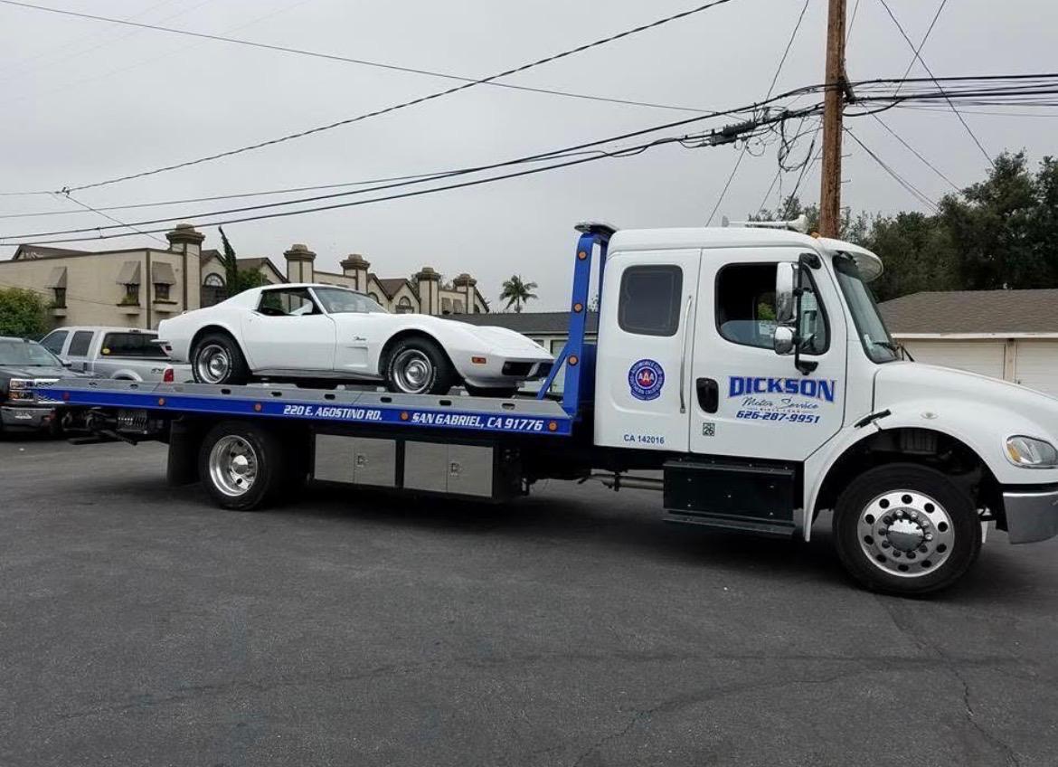 Dickson flatbed transporting a classic white 1971 Corvette Stingray