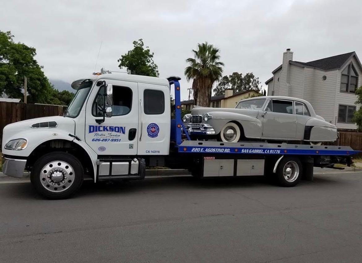 Dickson flatbed transporting a vintage Lincoln Continental